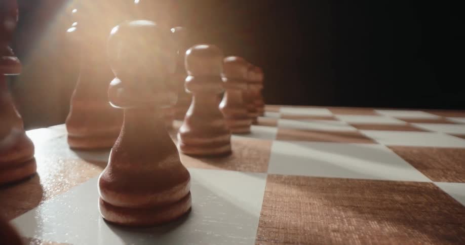 Wooden chess pieces over a board indoors during day time