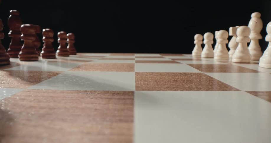 White and brown chess pieces positioned on opposite sides of the board