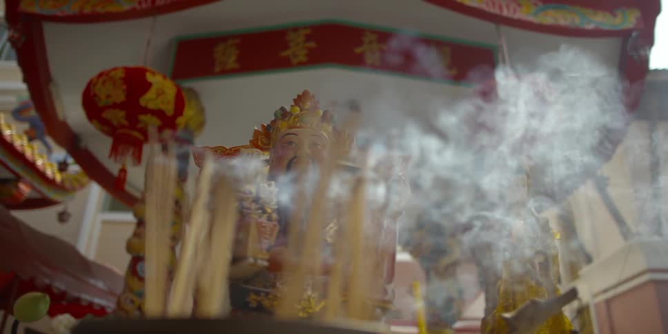 Smoke rises from the incense