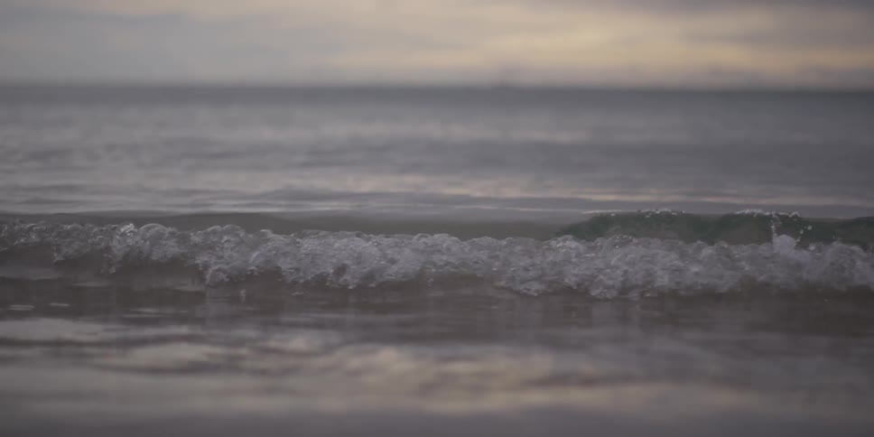 The waves crash against the shore