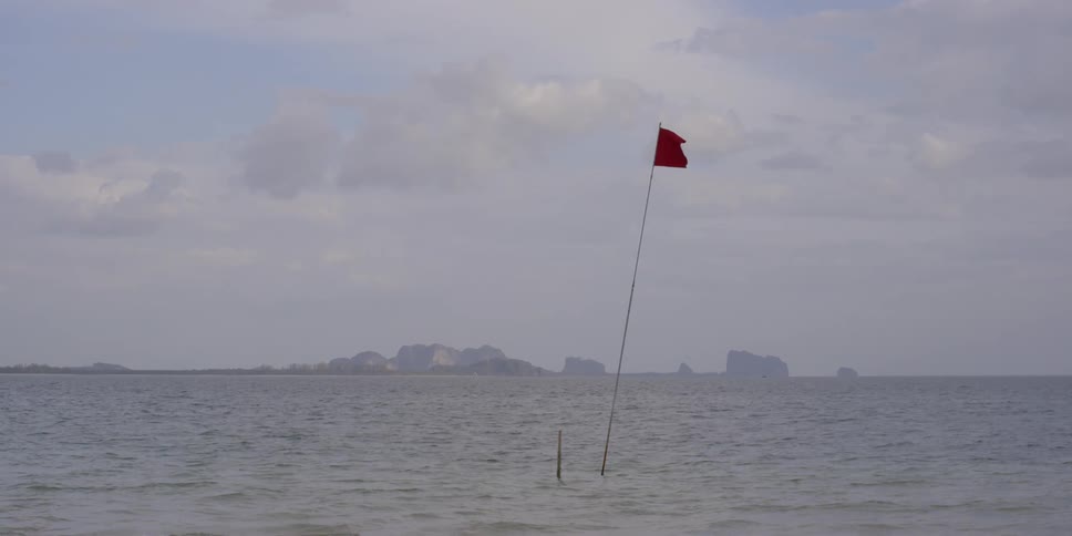 A flag sits in a rippling lake