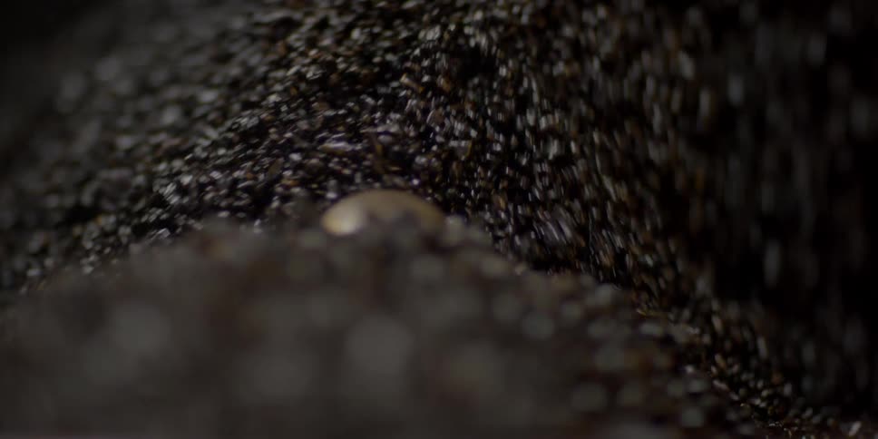 Dark pebbles swirling around in a machine