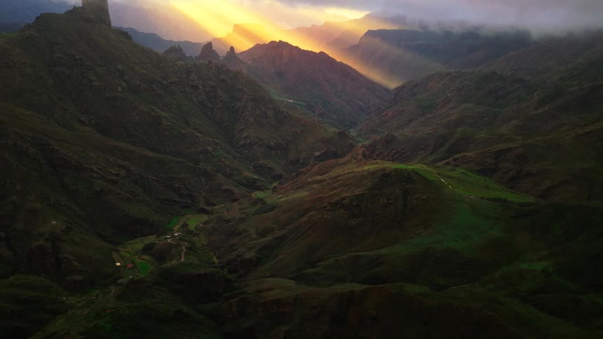 Mountainous region with green valleys outdoors during dusk or dawn