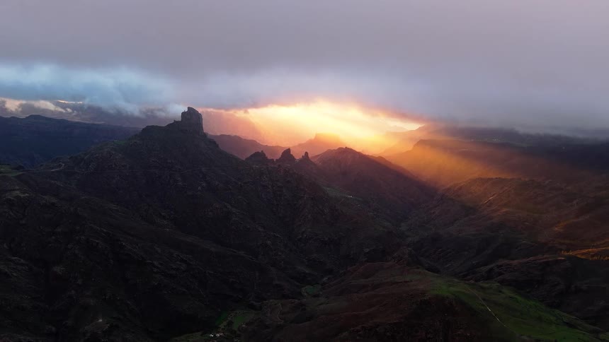 The sun shines over the mountain