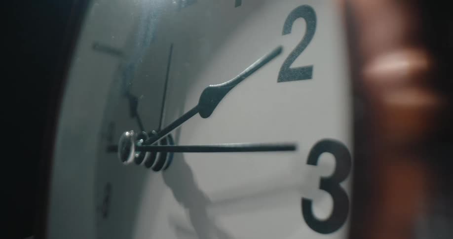 Second hand moves across the face of an analog clock