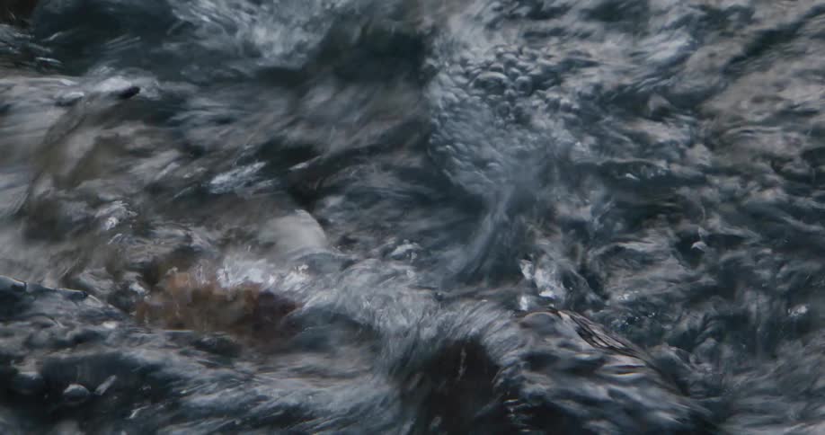 Flowing water with bluish reflections