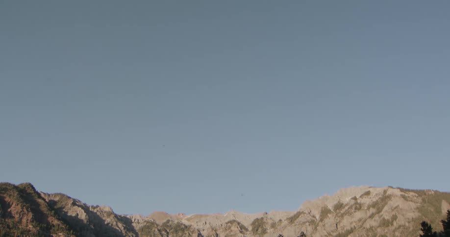Mountain range in the background beneath a clear sky occupying most of the frame