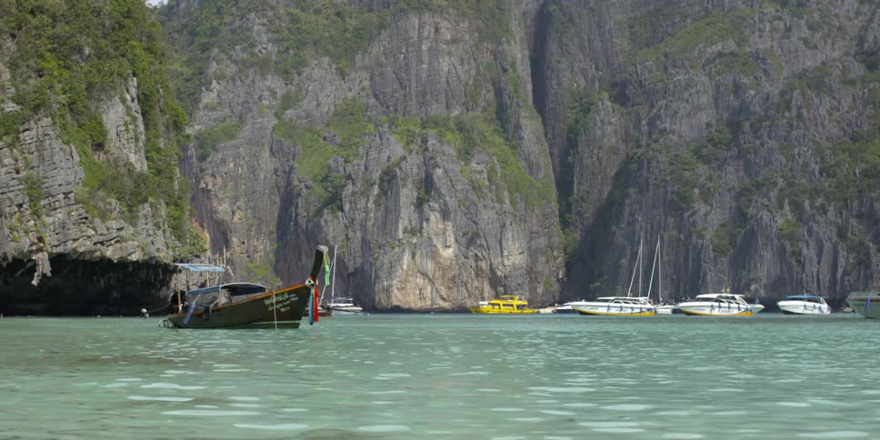 Boats are docked near canyons in the water