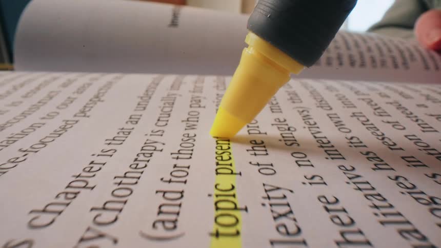 Hand highlighting text