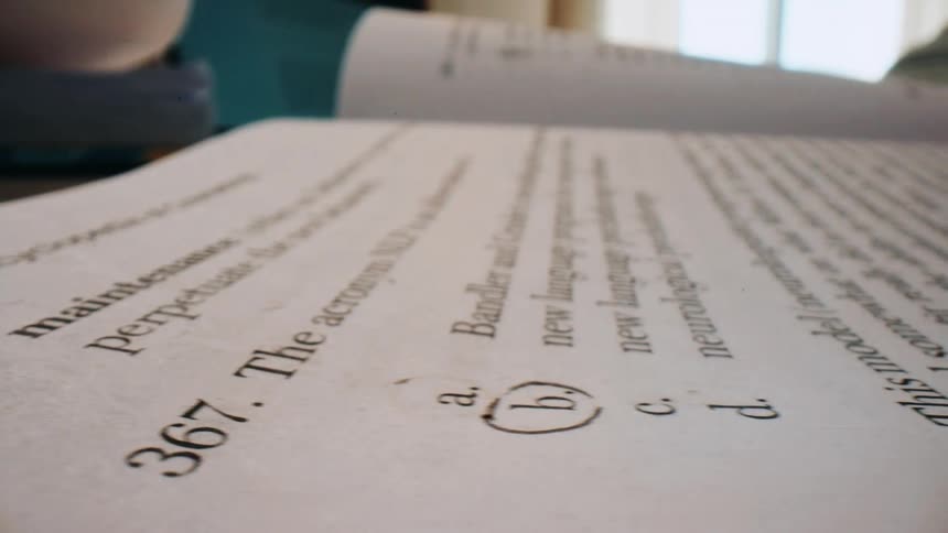 Pen is used to circle an answer on a test paper during the daytime