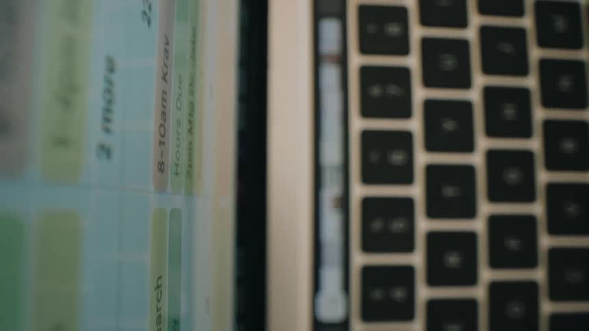 Laptop computer with text and numbers on the screen indoors