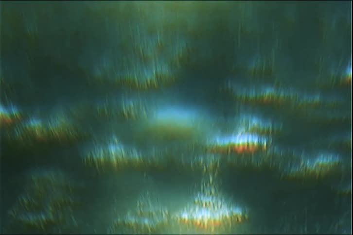 A background of shifting outoffocus light leaks in shades of teal gold and deep blue that mimic the look of vintage film or an underwater environmenta centered semitransparent watermark that displays the text filmsupply inside a rectangular box