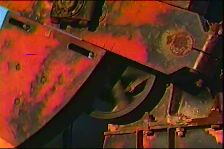 Rusty metal gear integrated into an industrial mechanism in closeup view