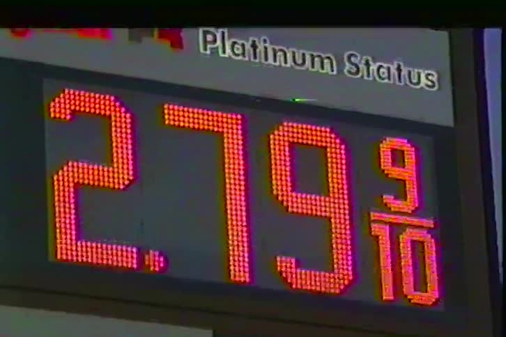 A digital gas price display with a retro vhsstyle aesthetic the two lines of text on the sign areplatinum status this appears at the top of the display in a clean white sansserif font against a dark background