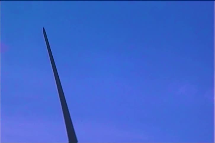 Threeblade wind turbine stands tall against clear blue sky