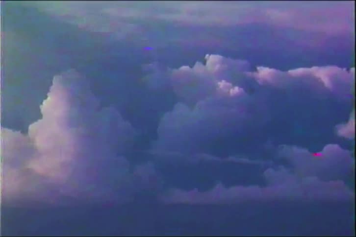 Layers of dense clouds seen from above with soft blue and purple tones