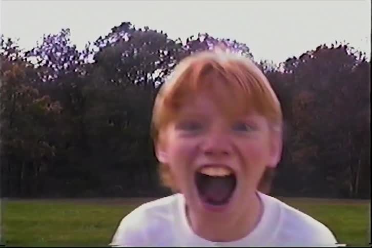 The child runs up and yells on the field