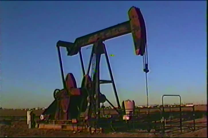 An oil derrick pumping out of the ground