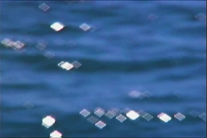 Diamondshaped reflections on rippling blue water