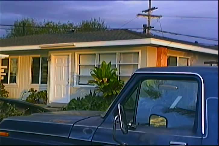 The truck is parked in front of the home