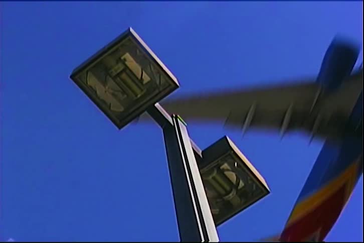 Modern dual street lamp contrasts with deep blue sky