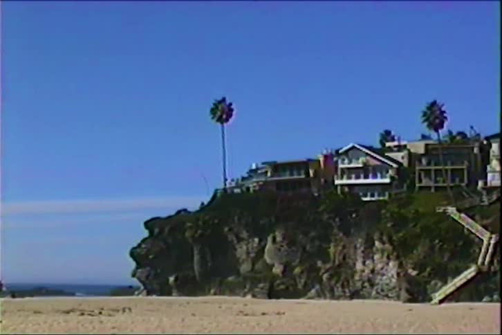 Staircase links sandy beach to cliffside houses