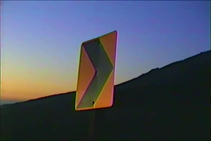 A close up of a road sign for a curve