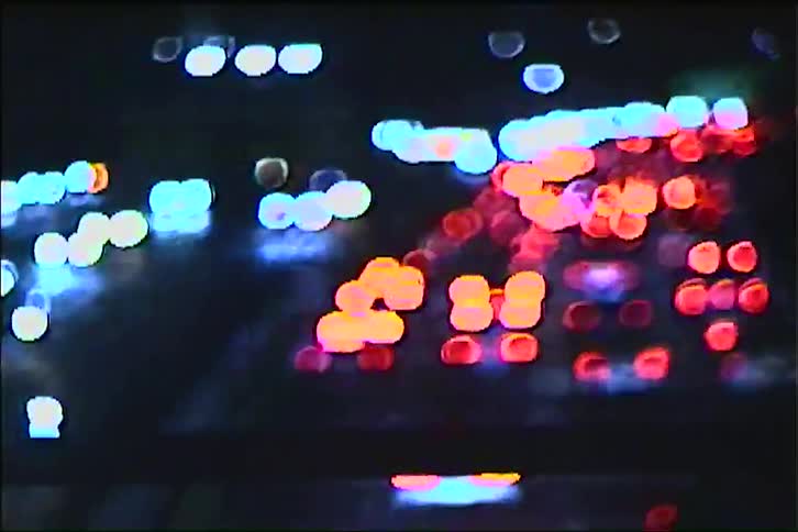 Outoffocus vehicle lights create vibrant bokeh effect on congested road at night