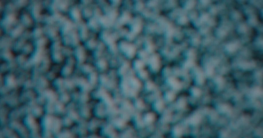 A closeup shot focusing on the physical subpixels of the screen you can clearly see the vertical columns of red green and blue light that compose the display these colored lines shift and flicker creating a textured pattern of digital noise