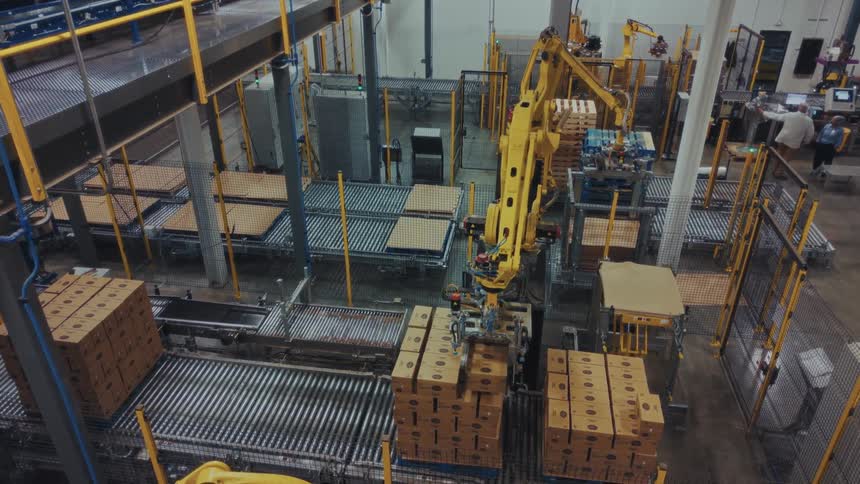 A robot stacking items on a pallet in a warehouse