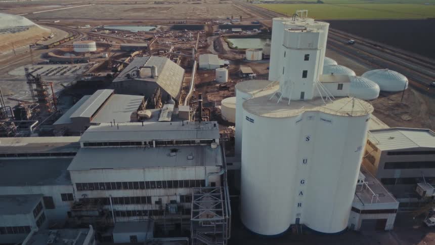 Large factory facing agricultural fields