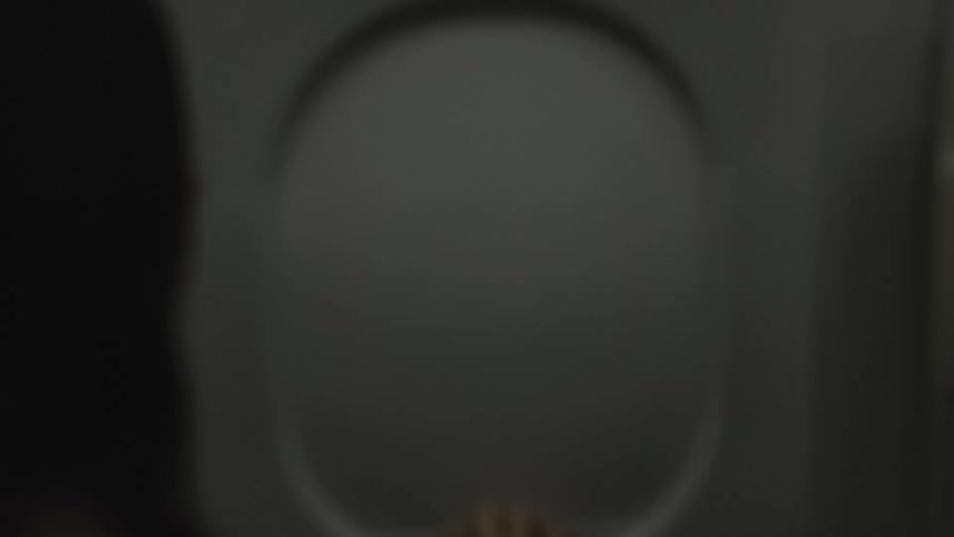 Person closing an airplane window