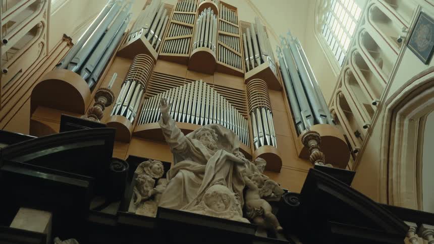 A giant pipe organ with a monument inside a classical church