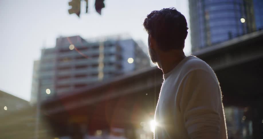 Man looking at buildings in a city