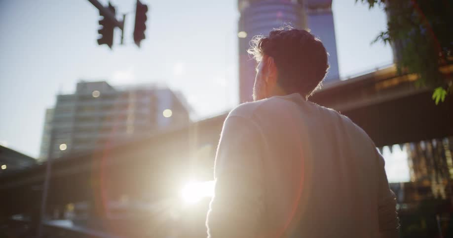 The man looks over the tall buildings in the city