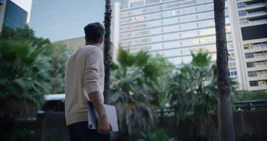 The man carries his laptop in the city
