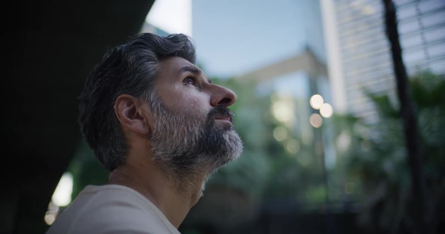 Bearded man looking upwards