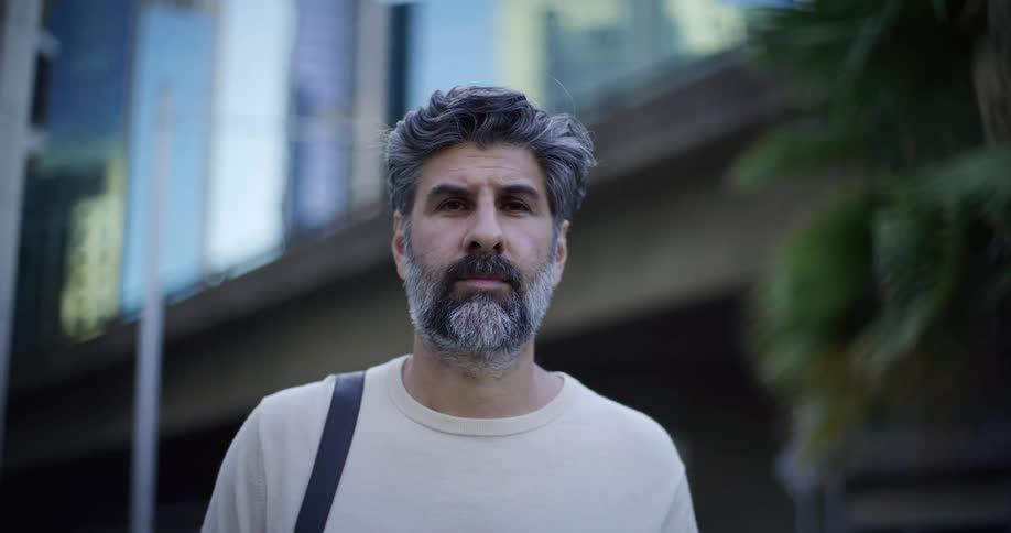 Man with a bag in an outdoor setting in the city