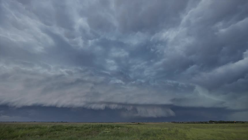 Fierce storm over a green field