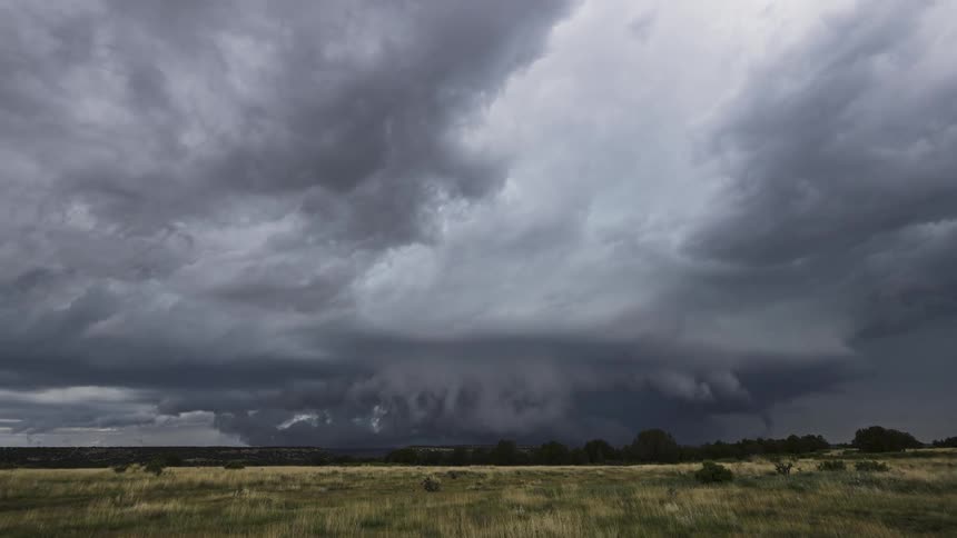 Storm clouds turn in rotation as a super cell moves over rural land