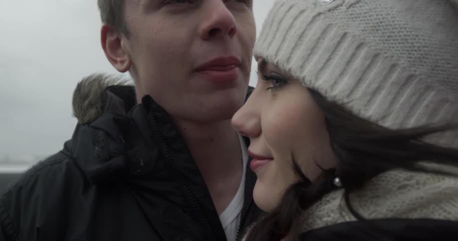 A man kisses a woman's forehead