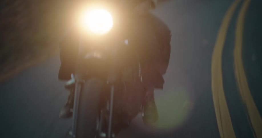 The headlight is bright on the motorcycle