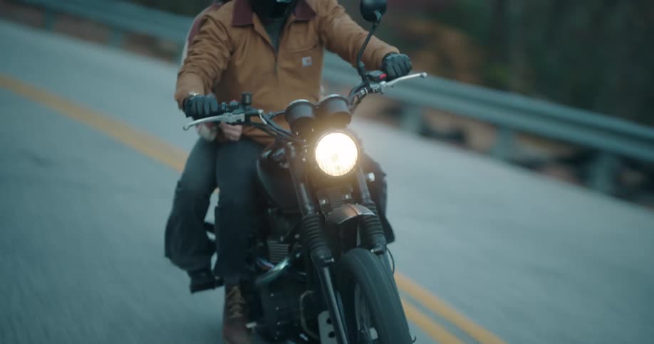 The motorcycle passes a car on the highway
