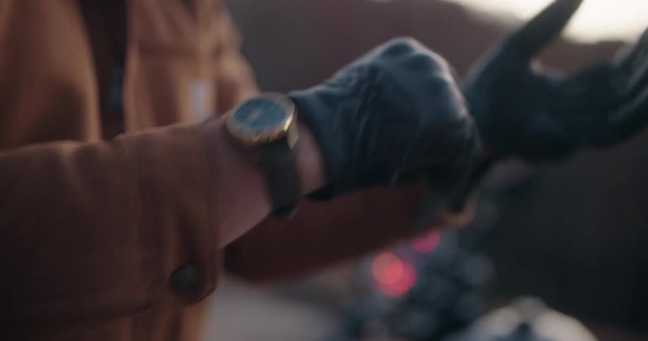A person putting on gloves outdoors
