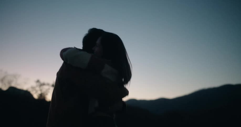Silhouette of a couple in a romantic moment outdoors