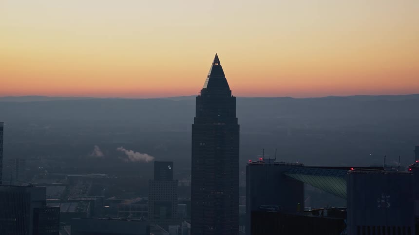 A city skyline at sunrise surrounded by skyscrapers and highrise buildings