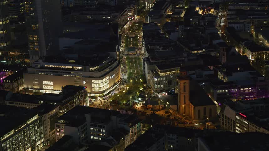Crowds of people walk in the city at night