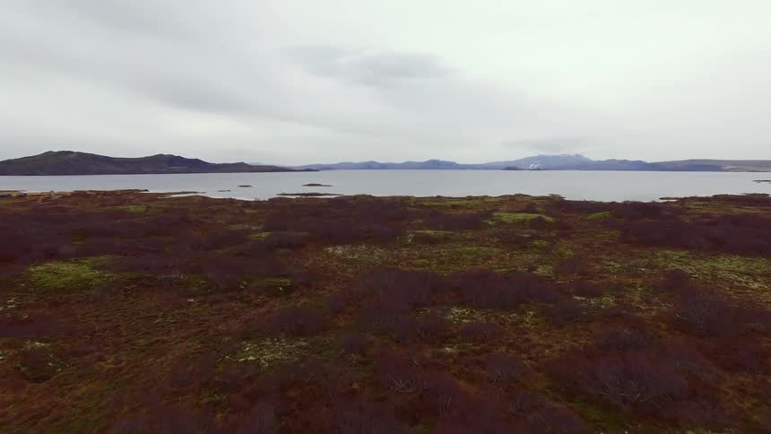 The brown fields lead to the lake ahead