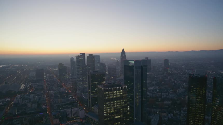Panorama of modern skyscrapers in a metropolis with the silhouette of mountains on the horizon