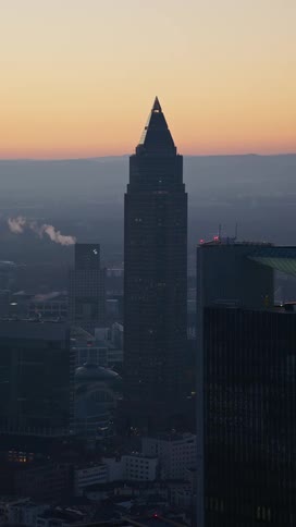 A tower in a city at sunset
